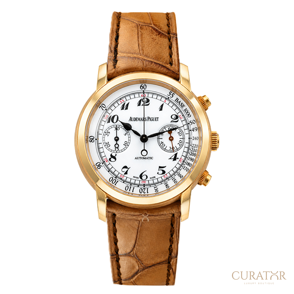 A luxury wristwatch by Audemars Piguet, featuring a gold-tone case, a white dial with black Arabic numerals and sub-dials, and a brown alligator-textured leather strap, shown against a plain white background.
